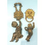 Two cast gilt metal door knockers, one in the form of Bacchus, the other the devil's mask and two
