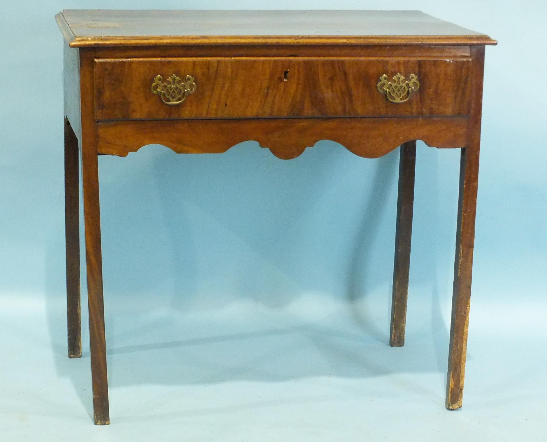 An antique mahogany rectangular side table, having a single frieze drawer, on square chamfered legs,