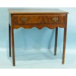 An antique mahogany rectangular side table, having a single frieze drawer, on square chamfered legs,