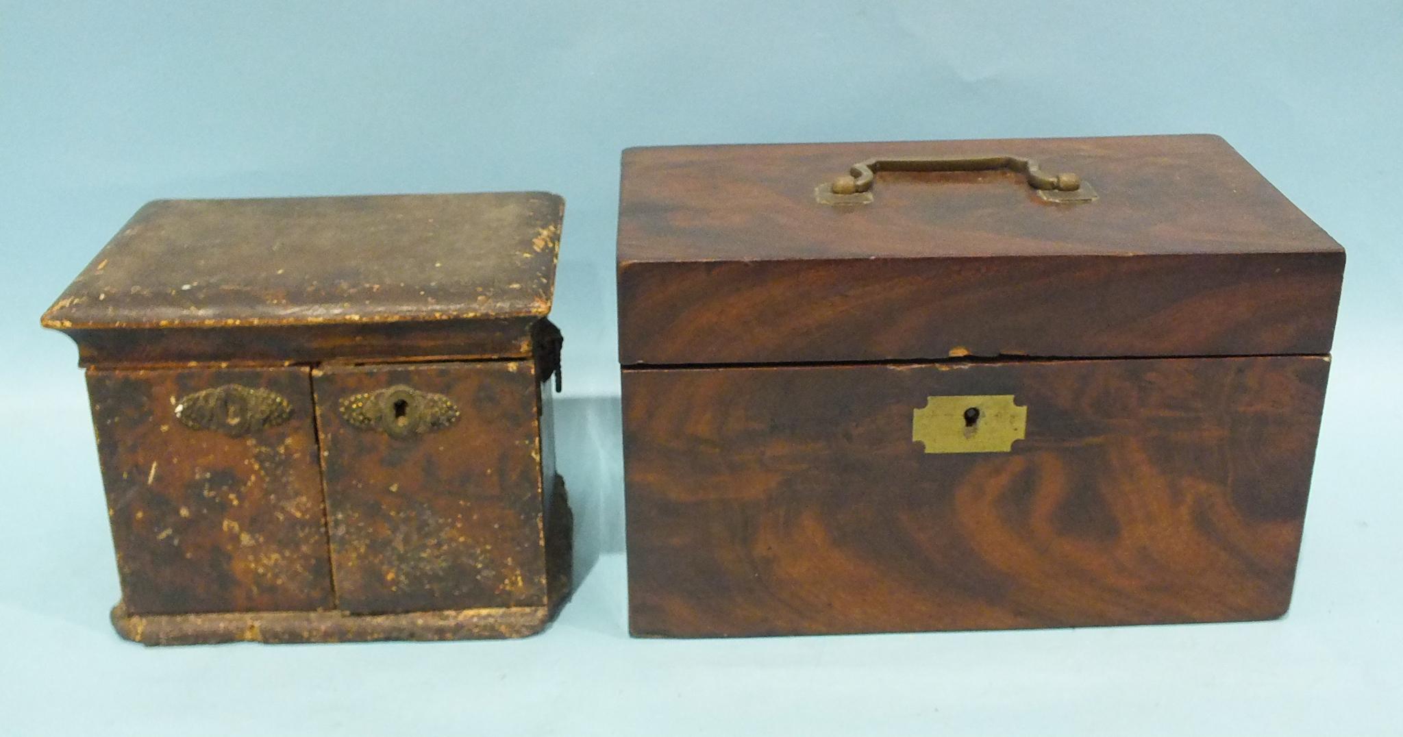 An early-19th century mahogany rectangular two-division tea caddy, the hinged lid revealing a pair