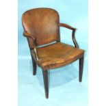 A 19th century mahogany leather-upholstered armchair, on square tapered legs.