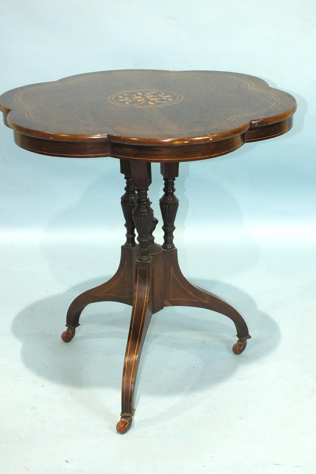 A Victorian inlaid rosewood centre table, the hexafoil top on three turned columns and downswept