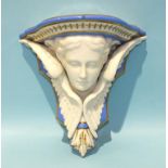 A 19th century English porcelain wall bracket modelled with a young woman's head supported by