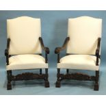 A pair of Continental stained carved wood armchairs of generous proportions, (2).