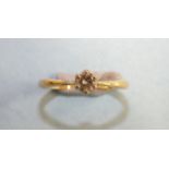 A solitaire diamond ring claw-set a brilliant-cut diamond of approximately 0.2cts, in 18ct yellow