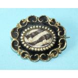 A Victorian 'husband and wife' mourning brooch of oval scrolling form, the inset blonde and brown