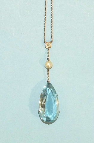 An early-20th century aquamarine, diamond and pearl pendant on chain, the pear-shaped aquamarine