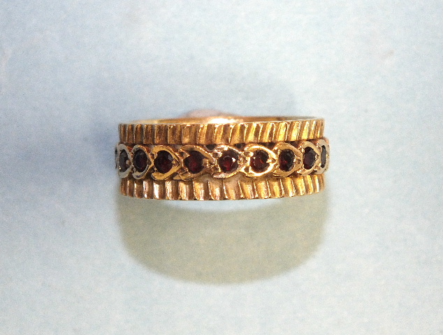 A 9ct gold eternity-style ring set garnets, size P, 4.6g.