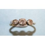 A three-stone diamond ring in 18ct gold and platinum mount, (very worn), size J, 1.7g.