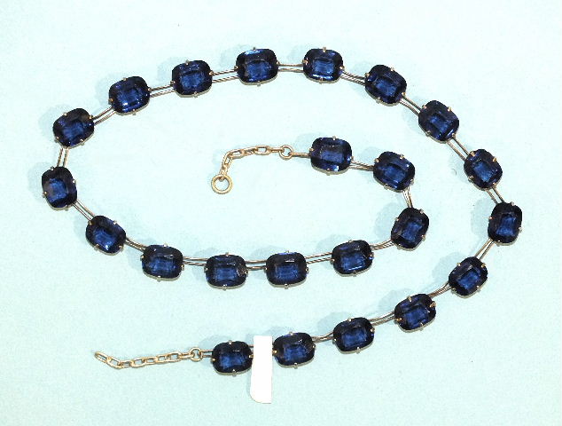 A rivière of sapphire-blue paste stones claw-set in white metal mounts, impressed Pat. App. For,