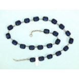 A rivière of sapphire-blue paste stones claw-set in white metal mounts, impressed Pat. App. For,