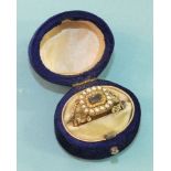 A Georgian mourning ring set with plaited hair panel, within engraved and pearl-set borders, between