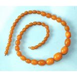 A string of orange Bakelite amber-style graduated beads, 71cm, 86g.