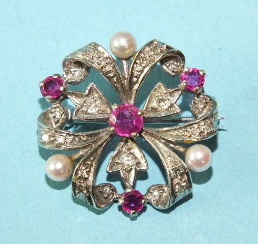 A 9ct white gold trefoil brooch set brilliant and 8/8-cut diamonds, round-cut rubies and cultured