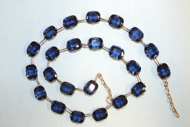 A rivière of sapphire-blue paste stones claw-set in white metal mounts, impressed Pat. App. For, - Image 2 of 2