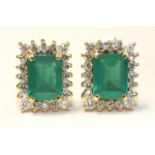 A pair of emerald and diamond cluster earrings, each rectangular emerald of approximately 1.8cts