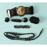 A lava stone cameo mounted in jet as a bracelet, a necklace of graduated faceted jet beads and other