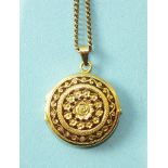 An 18ct yellow gold circular double locket, one side with raised flower and scroll decoration on