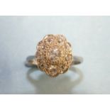 An Edwardian diamond cluster ring set nine old brilliant-cut diamonds, in platinum mount, size J½,