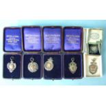 Six silver and gold medallions awarded to A Weston, all boxed.