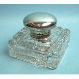 A very large cut glass inkwell with domed silver top, monogrammed and worn, complete with well, by