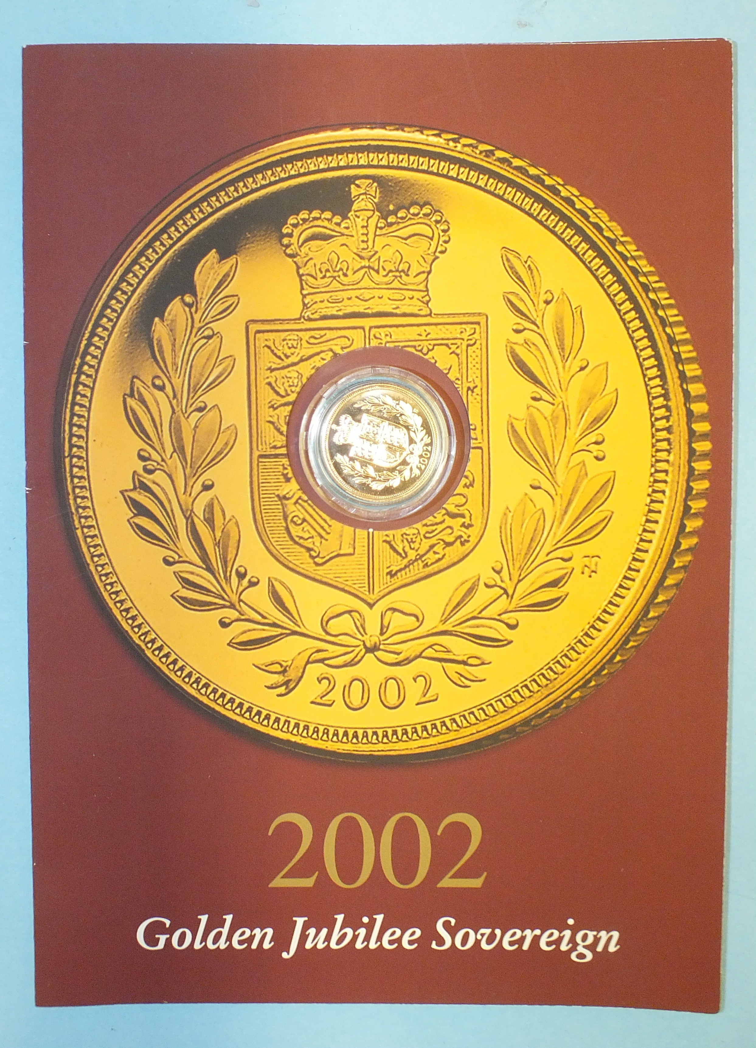 A 2002 Golden Jubilee sovereign in capsule and presentation card.
