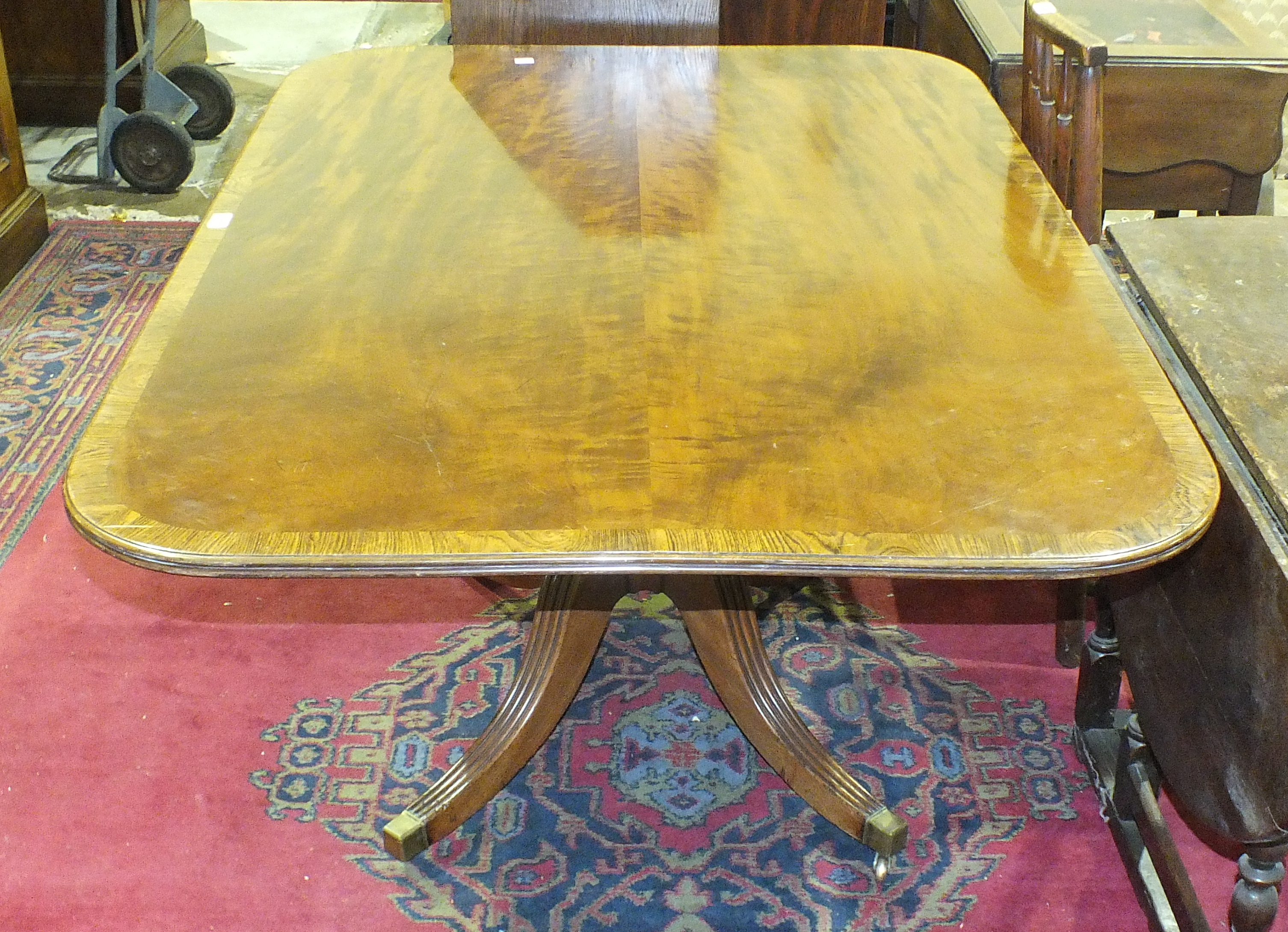 An antique mahogany tilt-top dining table, the well-figured top on quadruped support, 140 x 100cm - Image 2 of 3