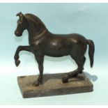 A bronze figure of a stallion with right foreleg raised, on rectangular marble base, 21.5cm high