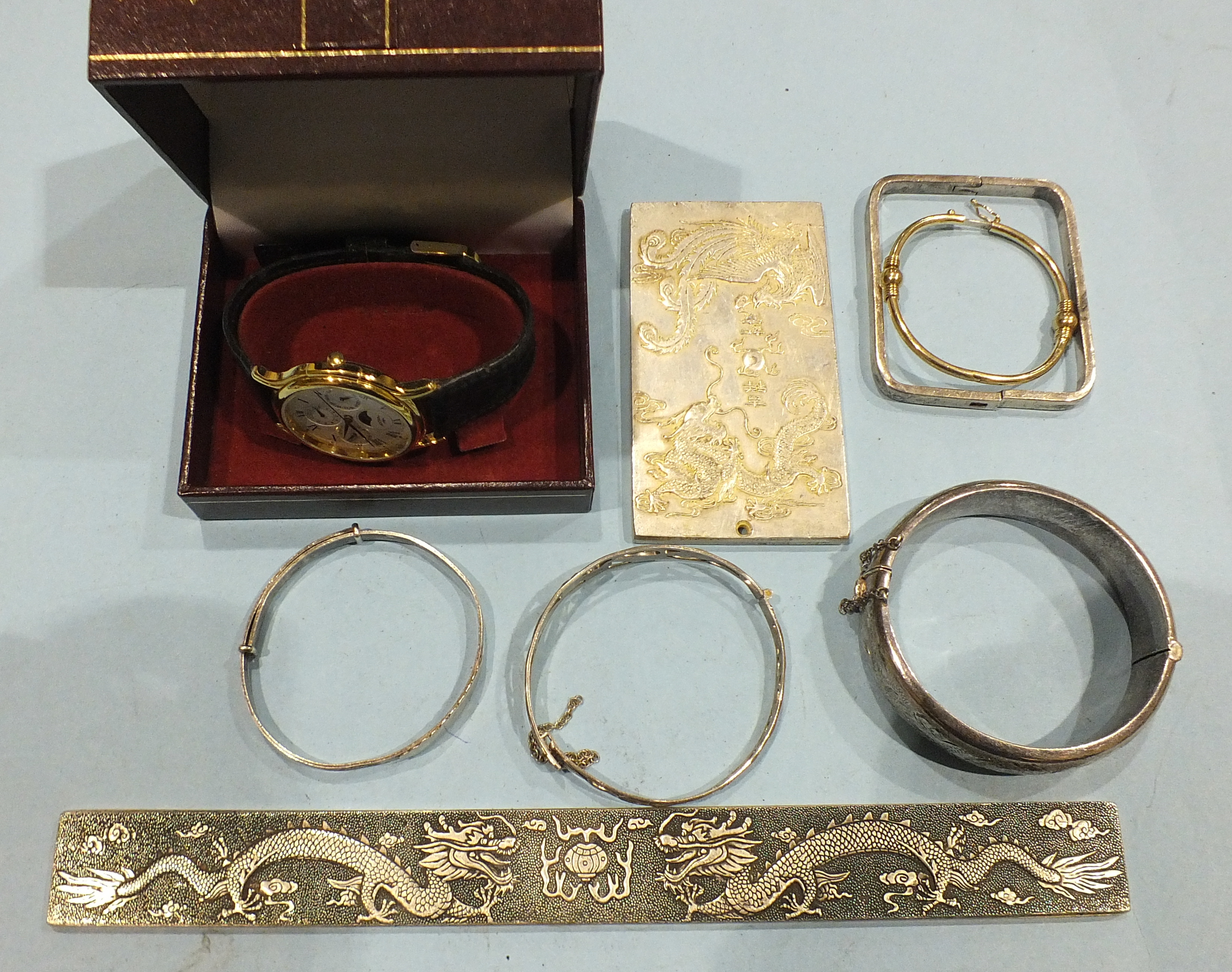 Four silver bangles, 67g, a child's plated bangle, two Chinese metal plaques and a gent's Rotary