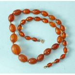 A string of faceted and graduated amber beads, largest 2 x 1.5cm, 20g.