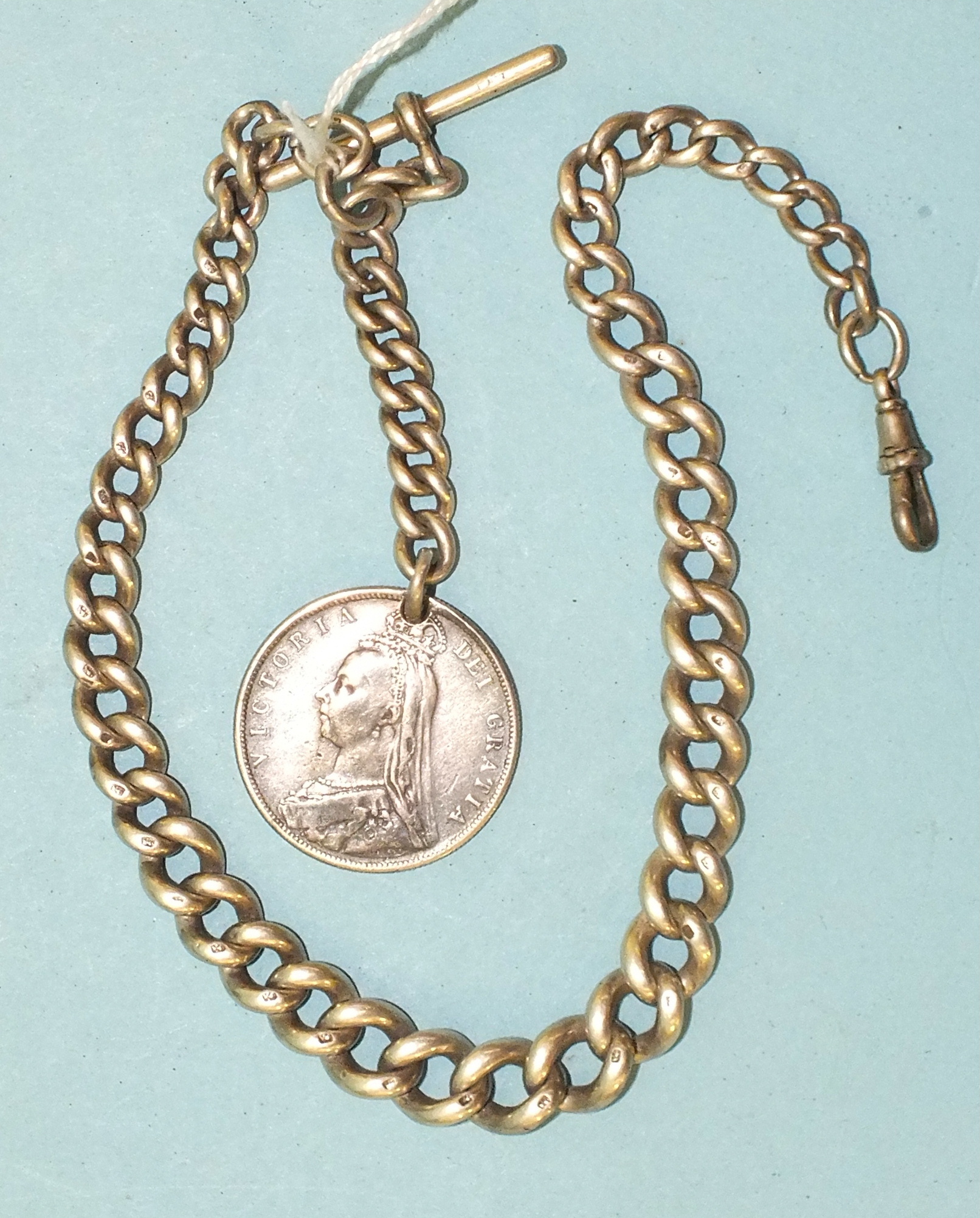 A silver graduated curb link half Albert watch chain with 1887 half-crown (holed), 78g.