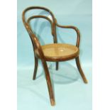 A child's Austrian bentwood chair with circular caned seat.