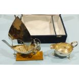 A small George II silver sauce boat with wavy rim and scroll handle, on three feet, 12cm long, maker