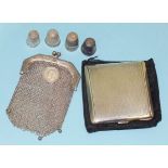 An engine-turned silver compact, Birmingham 1942, a small chain mail purse and four thimbles.