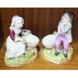 A pair of 19th century French porcelain sweetmeat figures of a boy and a girl seated with a basket