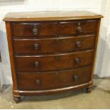 A late-Victorian stained mahogany bow-fronted chest of two short and three long drawers, on turned