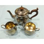 A silver three-piece plain bachelors tea service of bellied form, Birmingham 1931, stamped