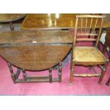 A small antique oak gate leg table with oval drop leaves on tuned legs, 93 x 106cm and a country-