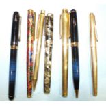 A Sheaffer gold plated fountain pen and propelling pencil, a Parker gold plated fountain pen, a Swan