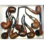 A collection of ten various briar pipes, all with silver collars.