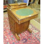 A Victorian walnut Davenport desk, the top with stationery compartments, hinged fall and fitted