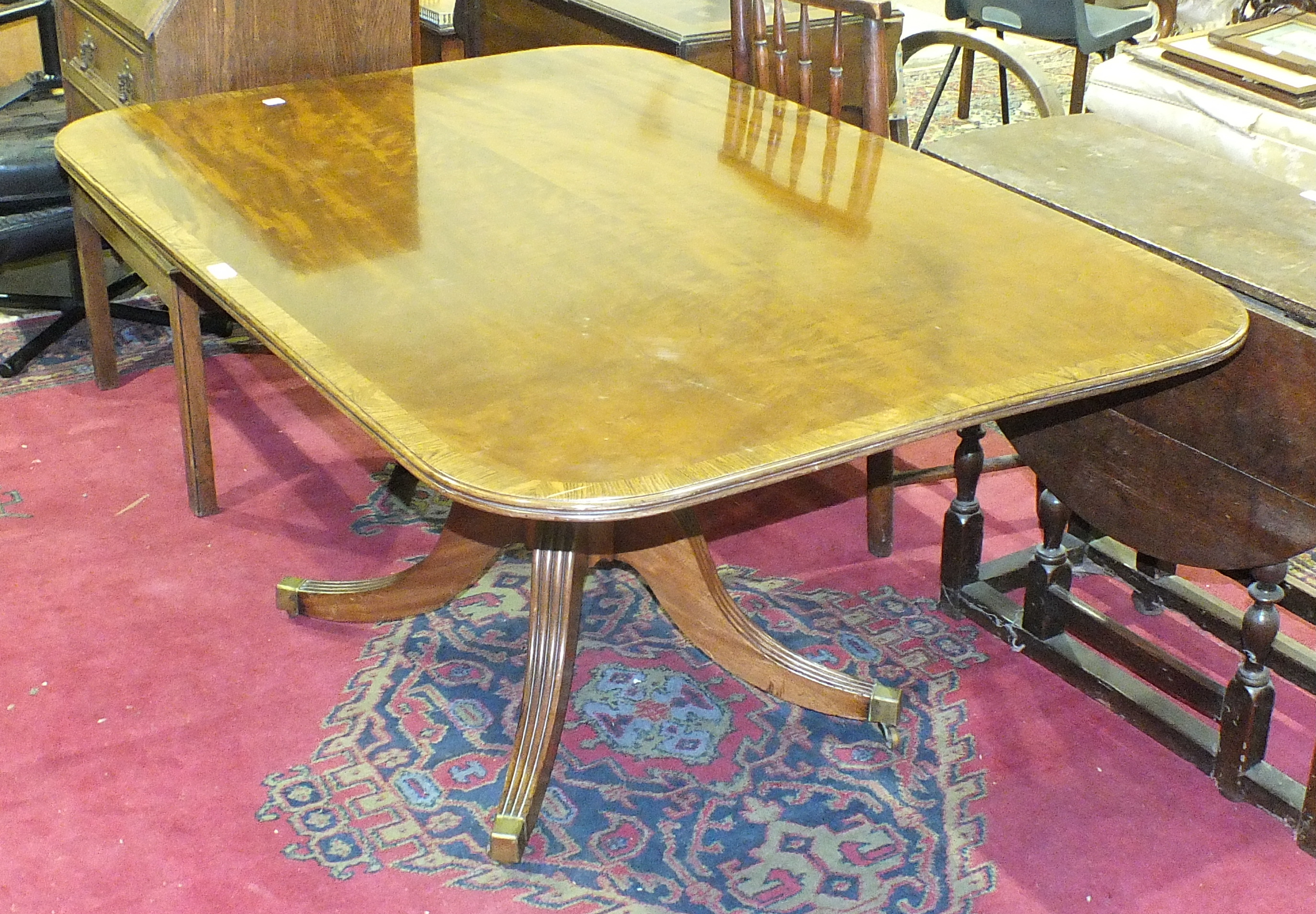 An antique mahogany tilt-top dining table, the well-figured top on quadruped support, 140 x 100cm