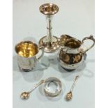 A silver christening mug, Birmingham 1938, (damaged), a loaded silver candlestick and other small