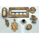 A silver napkin hook, a silver buckle and other small items of silver.