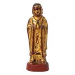 Statuette eines Mönches aus Bronze. SÜDOSTASIEN, 19. Jh. oder früherrote, schwarze und goldfarbene