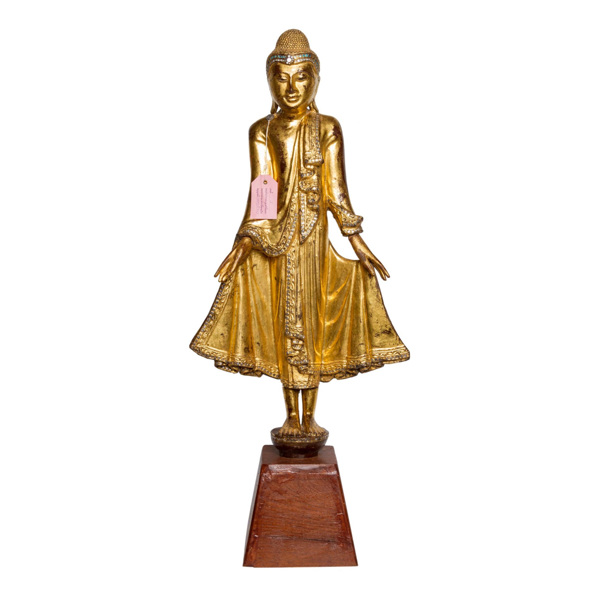 Holzfigur des stehenden Buddha. THAILAND, 20. Jh..Auf einem kleinen Sockel stehend, H 78 cm.