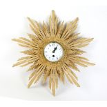 Carved pine sunburst clock with French drum movement, 50cm. CONDITION, enamel face has a very fine