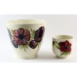 Moorcroft Pottery cache pot decorated in the Anemone pattern, against a white ground, painted and