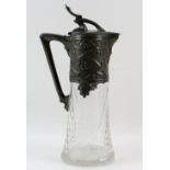 An Art Nouveau glass claret jug, the pewter mount with design of leaves and berries, 31 cm .