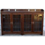Liberty & Co oak bookcase, with pierced heart back rail and leaded glass doors, ivorine label